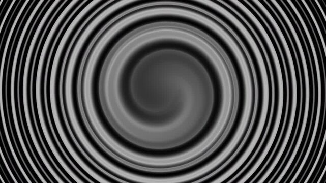 Overlap spiral blurred concentric circles create an overlapping spiraling abstract black and white background.