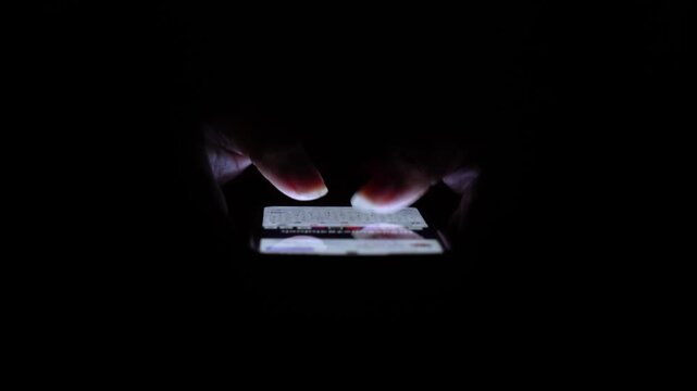 Person Using Smartphone in Dark Room.