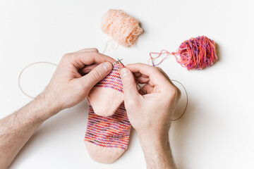 Close-up of male hands knitting. Process of knitting. Hand made.
