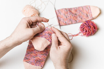 Close-up of male hands knitting. Process of knitting. Hand made.