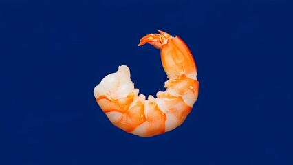 Single shrimp on a blue background, peeled and partially eaten.