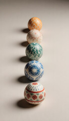 Hand-painted Easter eggs arranged in a neat line on neutral surface  