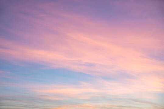 Pastel clouds in the evening sky. Pink and light purple.