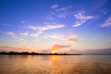 Vivid cloudy sky sunset by the river in eastern Thailand, sunset by the river background