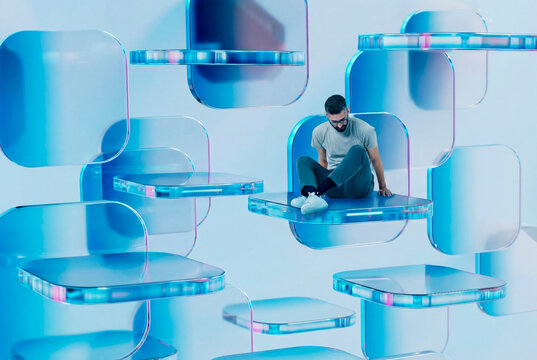 Man resting on 3D cube shapes in digital background