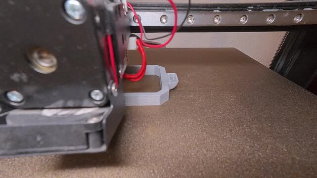 Hyperlapse of a 3D printer creating a plastic part on the build plate. Additive manufacturing process, rapid prototyping and modern digital fabrication technology in action