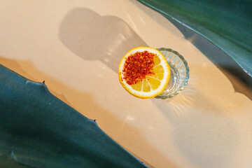 Mezcal shot with lime and chili salt on agave leaf