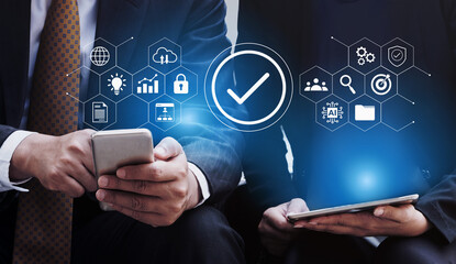 Two business professionals utilize a mobile device and a tablet, surrounded by digital icons representing security, analytics, and collaboration in a modern workspace. Gantry