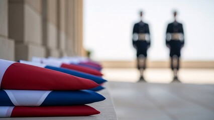 Folded flags on steps with soldiers in background