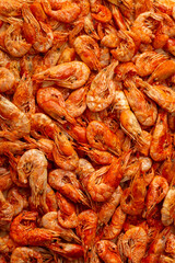 Shrimp close-up in a large pile. Smoked and salted shrimp with spices for a beer snack.