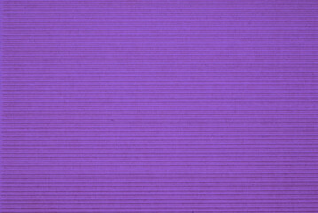 Fototapeta premium Corrugated cardboard background with purple texture. Minimal recycled paper surface for eco design, packaging, craft projects, sustainability concepts and copy space.