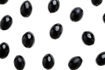 Glossy black olives scatter against dark backdrop