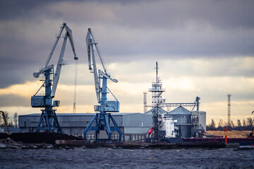 Industrial crane in a port with overcast sky