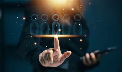 Hand touching virtual user icons, symbolizing customer selection, target audience, user segmentation, human resources, recruitment, and digital people management strategy.
