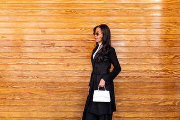 Latina asian businesswoman standing outdoors with sunglasses