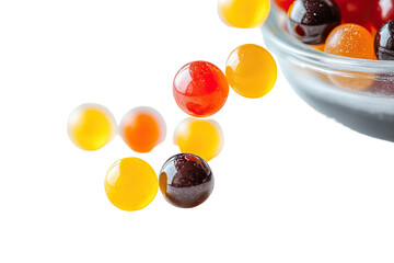 Colorful, glossy candy spheres spill from a glass bowl