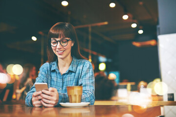Night, coffee and woman in restaurant, smartphone and typing with social media, relax and bokeh. Evening, person and customer with happiness, cappuccino and cellphone with message to contact and text
