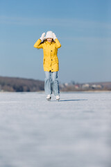 Young woman enjoying ice skating on a frozen lake