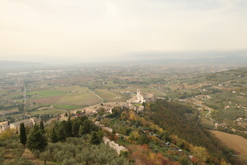 A view of the Umbrian countryside, Italy. Plains, mountains, and a cloudy sky.