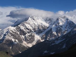Obraz premium Snowy mountains in the clouds in the Caucasus