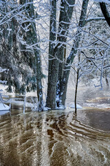 Flooding ice covered river in very cold winter day