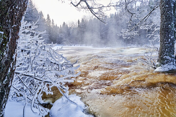 Flooding ice covered river in very cold winter day