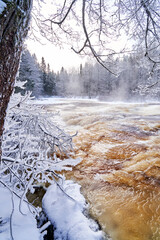 Flooding ice covered river in very cold winter day