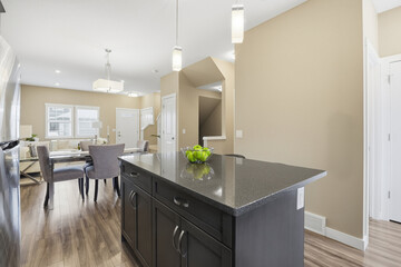 Kitchen with a granite countertop and a bowl of fruit on it