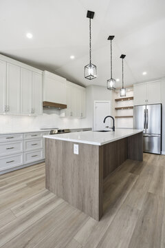 Kitchen with a white island and a silver refrigerator