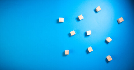 White sugar cubes on a blue background. Toned. Copy space.