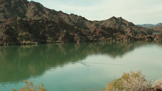 Bill Williams River beautiful mountains reflecting on calm water in Arizona and duck swimming