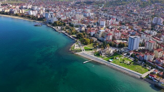 High aerial video of Pogradec city and turquoise waters of Lake Ohrid, Albania.