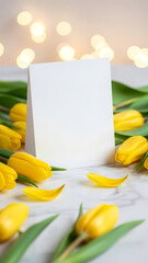 Blank white greeting card mockup with yellow tulips. Vertical template of celebration concept for Mother's Day or Valentine's Day invitation, holiday message with copy space.