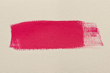 Macro smear of pink acrylic paint on white paper