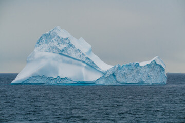 Epic Iceberg Antarctica. A Picture Perfect Floating Ice with Snow. Fine Art Photography. Penguins Standing on Corner. On Open Ocean.