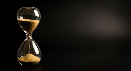 A hourglass on black background