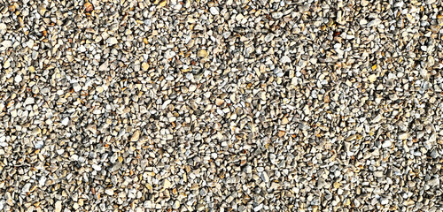 Small gravel stones texture background. Natural crushed stone surface with rough detail, suitable for construction, design, and abstract backgrounds.