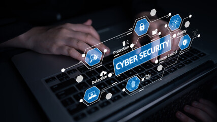 A close-up image showing hands on a laptop with cyber security graphics highlighting key elements like protection, detection, and access control for online safety. Tessel