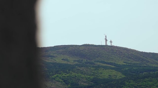 Cross and telecommunication tower on Vodno mountain under clear sky in Skopje, Macedonia