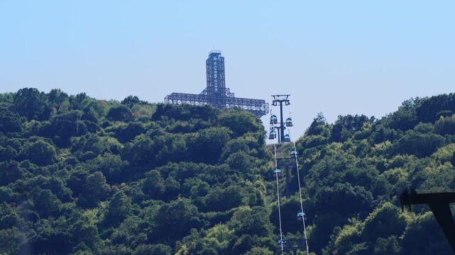 Majestic view of Cross with cable gondola lift located on Vodno mountain hill in Skopje