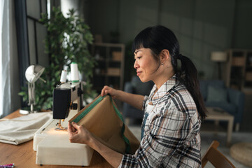 Woman learning tailoring skills on a sewing machine