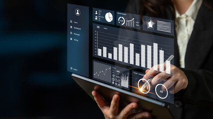 A business professional engages with a tablet displaying dynamic data visualizations, including graphs and statistics, to enhance decision-making processes. Impute