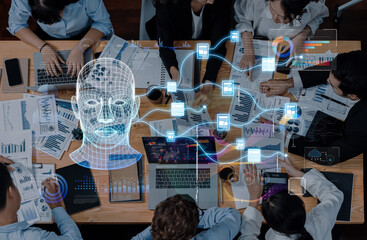 A diverse team collaborates in a modern workspace, utilizing technology and data analysis to innovate artificial intelligence strategies and enhance productivity through effective teamwork. Trope