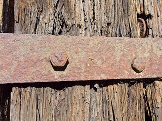 wood plank with rusty iron strap
