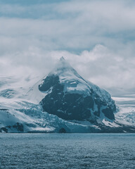 Sharp Pointy Peak Mountain in Antarctica Elephant Island. Vertical Orientation Ocean Sunny Day Remote Destination Beautiful Nature © And They Travel
