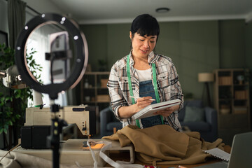 Woman creating online sewing tutorial video at home