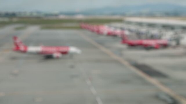 Bokeh view of aircrafts in Lapangan Terbang Antarabangsa Kuala Lumpur from arrival zone, Sepang, Selangor, Malaysia. Blurred background footage.
