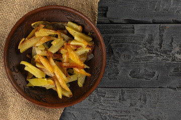 Rustic Plate of Homemade Oven-Baked Fries on Wooden Table Top