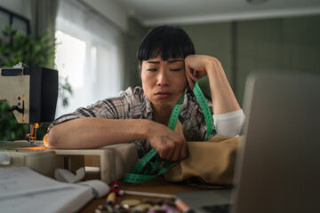 Woman tailor experiencing burnout and stress from work