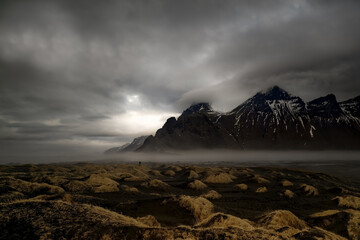 Distant view of a photographer taking a photo of Vestrahorn mountain, Stokksnes Peninsula, Iceland